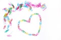 Colorful paperclips and heart on the white Royalty Free Stock Photo