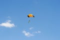 Colorful parachute in the clear blue summer sky Royalty Free Stock Photo