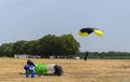 Colorful parachute landing as storm is coming