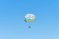 Colorful parasailing parachute against a clear blue sky. Royalty Free Stock Photo