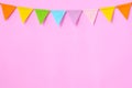 Colorful party flags hanging on pink background, birthday, anniversary, celebrate event, festival greeting card background Royalty Free Stock Photo