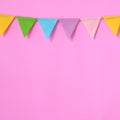 Colorful party flags hanging on pink background, birthday, anniv Royalty Free Stock Photo