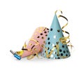 Colorful party hats, blowers and confetti streamers on white background Royalty Free Stock Photo