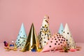 Colorful party hats and festive items on pink background Royalty Free Stock Photo