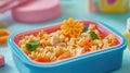 Colorful pasta salad in blue lunchbox with chicken and vegetables Royalty Free Stock Photo