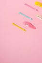 Colorful pastel accessories hairpin on pink background, close up, trendy modern from past