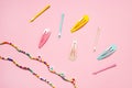 Colorful pastel accessories hairpin on pink background, close up, trendy modern from past