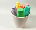 Colorful pastel color highlighter markers in a pink plastic cup, isolated Royalty Free Stock Photo