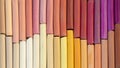 Colorful pastel crayons in warm colors in two rows as background Royalty Free Stock Photo