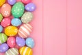 Colorful pastel Easter Egg side border against a pink wood background Royalty Free Stock Photo