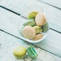 Colorful pastel French macaron biscuits in glass, copy space