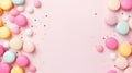 Colorful pastel pink, blue, yellow and green candy drops and sprinkles on a pink background