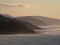 Colorful pastel sky sunrise view of mountain silhouette layered seaside hills at Castle Point, Wellington New Zealand Royalty Free Stock Photo