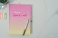 Colorful pastel white notebook for journal or diary on marble texture table.Work life balance quote phrase on book cover