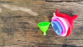 Colorful pastic funnels with handle on old wooden table Royalty Free Stock Photo