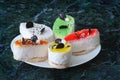 Colorful pastry cakes with chocolate on grunge background, selective focus