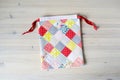 Colorful patchwork drawstring bag on table Royalty Free Stock Photo