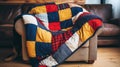 Colorful patchwork quilt draped over comfy armchair. Royalty Free Stock Photo