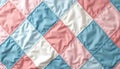 Colorful patchwork quilt with pastel squares in pink, blue, white. Modern geometric pattern crafted from fabric with visible Royalty Free Stock Photo