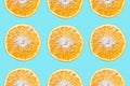 Colorful pattern of cutted orange fruits, isolated on background of cyan or aqua menthe color. Royalty Free Stock Photo