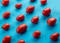Colorful pattern of red tomatos on blue background. Flat lay. Food concept. Royalty Free Stock Photo
