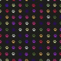 Colorful paw prints seamless fabric design pattern with black background Royalty Free Stock Photo