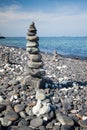 Colorful pebbles touching wave at beautiful rock island, called Koh Hin Ngam, near Lipe island, Thailand