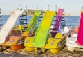 Colorful pedalos or paddle boats with toboggan on beach.Summer concept with pedal boats with the Mediterranean sea in background. Royalty Free Stock Photo