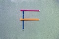 Colorful pen set to English consonant on gliter background