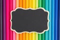 Colorful pencil crayon education background with a chalkboard