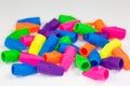 Colorful pencil erasers cluttered on a white surface Royalty Free Stock Photo