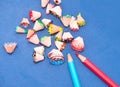 Colorful pencil shavings together with pencils Royalty Free Stock Photo