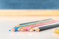 Colorful pencils against a blurred blackboard background Royalty Free Stock Photo