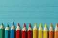 Colorful pencils arranged neatly beside a blank notepad in an organized office workspace Royalty Free Stock Photo