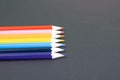 Colorful pencils arranged in a wave isolated over black background Royalty Free Stock Photo