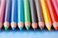 Colorful pencils on a blue background. Close-up, Colored pencils in a row, close-up, macro, AI Generated Royalty Free Stock Photo