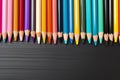 Colorful pencils border on white backdrop