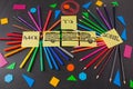 Colorful pencils in circles, titles Back to school and school bus drawn on the pieces of paper on the chalkboard Royalty Free Stock Photo