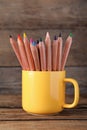 Colorful pencils in cup on wooden table Royalty Free Stock Photo
