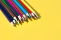 Colorful pencils for draw and study in school. Bright school supplies on yellow