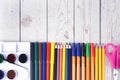 Colorful pencils, markers and pens composition back to school, concept with stationery on a cramped wooden background Royalty Free Stock Photo