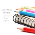 Colorful pencils and notebook isolated over white Royalty Free Stock Photo