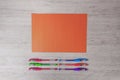 Colorful pencils and orange paper on the desk. Royalty Free Stock Photo