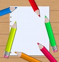 Colorful pencils on paper sheet background