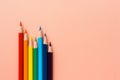 Colorful pencils on pink background