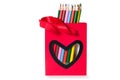 Colorful pencils in a red bag with heart shape