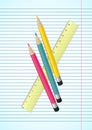 Colorful pencils and ruler on ruled paper