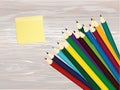 Colorful pencis. Yellow sheet of paper for notes. Sticker. Vector on wooden background Royalty Free Stock Photo