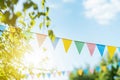 Colorful pennant decoration in green foliage on blue sky Royalty Free Stock Photo