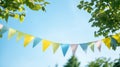 colorful pennant string decoration in green tree foliage on blue sky, summer party. Generative Ai Royalty Free Stock Photo